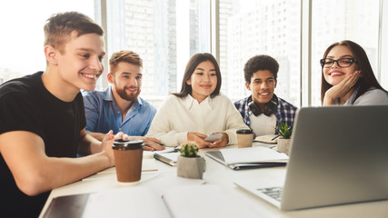 Tutorial video. Students using laptop in university library