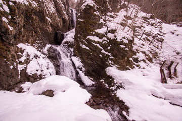 Fototapeta na wymiar Snow scene and waterfall