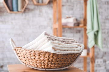 Fototapeta premium Basket with clean towels on table