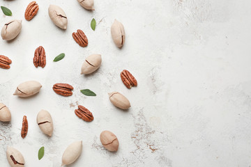 Tasty pecan nuts on light background