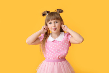 Cute little girl on color background