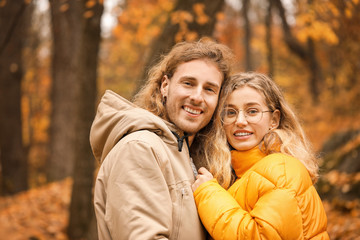 Fototapeta premium Young couple in park on autumn day