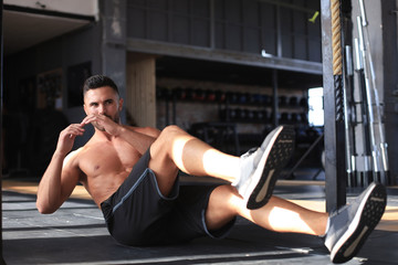 Fototapeta na wymiar Sporty man stretching and warm-up doing special exercises for muscles before work his body out.