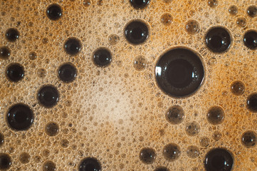 Air bubble foam formed on freshly flavored black coffee.
