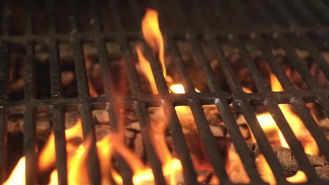 flaming charcoal grill with open fire, ready for product placement. Concept of summer grilling, barbecue, bbq and party.