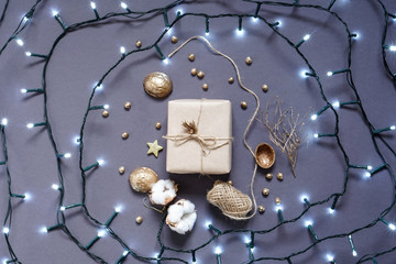 Gift wrapped in craft paper , decoration natural materials and led garland. Photo
