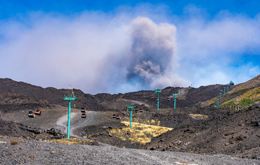cable car on etna volcano with eruption on sicily island, italy