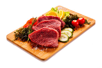 Fresh raw beef on cutting board on white background