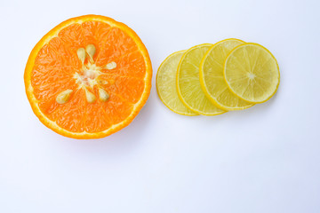 Fresh organic half cut orange and sliced yellow lemon on white background, Isolated.