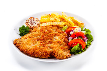 Fried pork chop, French fries and vegetables