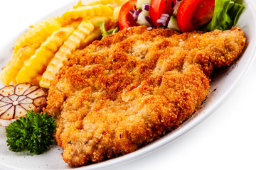Fried pork chop, French fries and vegetables