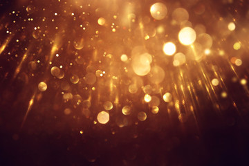 Fototapeta na wymiar background of abstract glitter lights. gold and black. de focused