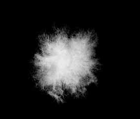 Beautiful white feather shaggy floating in air isolated on black background