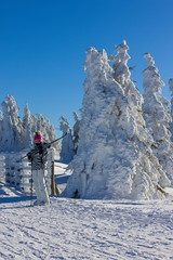 Girl with ski on the mountain