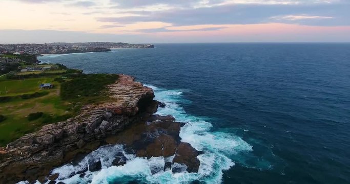 The Beautiful Rocky Shores Of The Tamarama Beachside Suburb In Sydney, Australia With The City In The Background - Aerial Shot