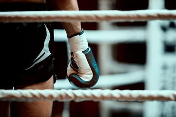 Muaythai boxer hand on the ring rope during the break