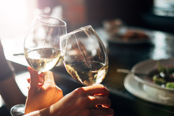 Toast glasses of wine in restaurant