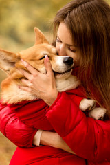 young woman kisses and hugs her dog