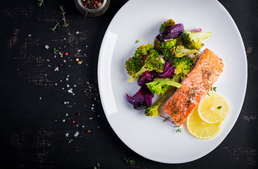 Baked salmon fillet with broccoli, red onion and lemon. Top view, overhead