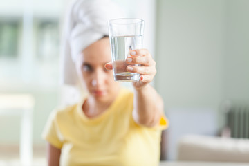 Young woman with a glass of water