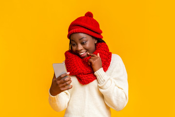 Emotional winter girl checking on new phone app