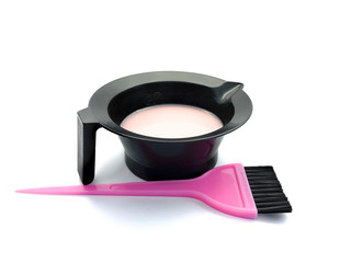 Bowl for paint and pink brush isolated on a white background. Hairdressing set for hair coloring....
