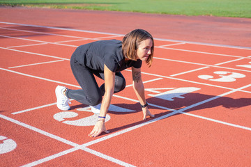 Fototapeta premium Young female runner training in summer day outdoors on the studium 
