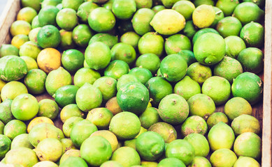 various colorful fresh fruits limes, in the fruit market, Catania, Sicily, Italy.