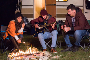 Caucasian girl roasting marshmallow over camp fire