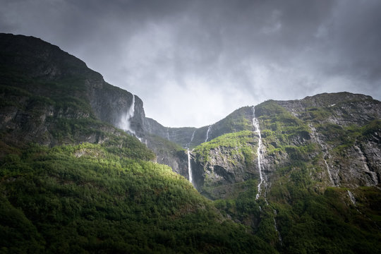 Water pouring down at cascade in dark weather mountain scenery Norway