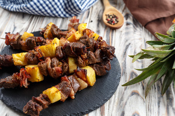 meat kebab with pineapple and bacon