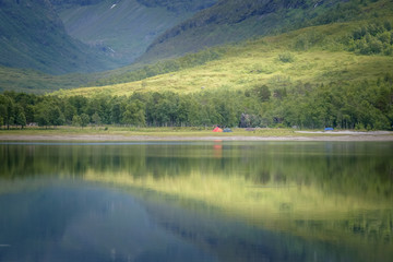 Fototapeta na wymiar Camping with tents at lake in Innerdalen mountain national park beautiful scenery