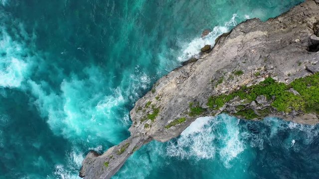 Aerial view at sea and rocks. Turquoise water background from top view. Summer seascape from air. Kelingking beach, Nusa Penida, Bali, Indonesia. Travel - video