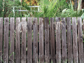Old low and painted fence on a cloudy day front view