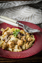 Tagliatelle pasta with forest mushrooms and chicken.