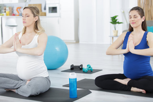 Two Pregnant Women Talking In Yoga Class