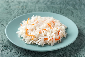 sauerkraut with carrots on a green plate
