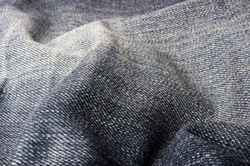 clothing items blue stonewashed faded jeans cotton fabric texture with seams, clasps, buttons and...