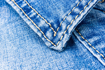 clothing items blue stonewashed faded jeans cotton fabric texture with seams, clasps, buttons and...