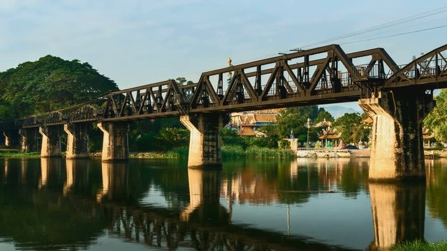 4K Time lapse of sunrise over railway crossing river Kwi. Kanchanaburi, Thailand. Historical raiway during world war II. Camera zoom in.