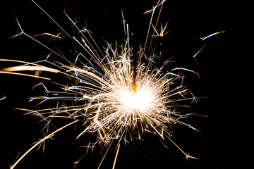 Close-up of bright Bengal lights on black background.