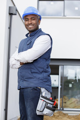 workman with helmet keeping the arms crossed in frontal position