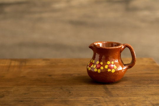 Mini traditional mexican clay cups on a wooden surface against a rocky  background Stock Photo | Adobe Stock