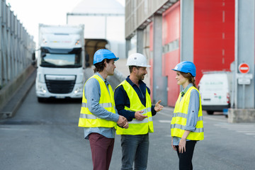 workers talking on the loading dock of a factory