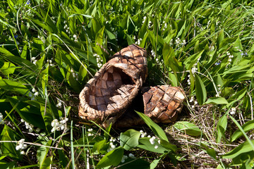 Braided bark sandals on the background of green grass
