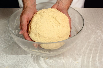 Shape dough into ball and place it in bowl. Dough ready before rising. Making Yeast Sweet Roll Bun