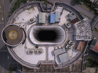 Kuching, Sarawak / Malaysia - November 15 2019: Creative shot - an aerial top down view of a donut shaped building in Kuching, the island of Borneo. The core of the building was empty.