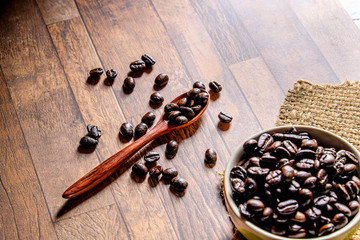 Roasted coffee beans on a wooden spoon