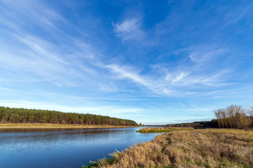 Obraz premium The blue sky with the clouds above the clear blue river.