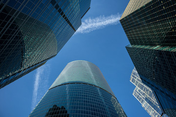 Modern business center in Moscow city. Modern urban architecture, glass skyscraper, office building on a sunny day, view from below.